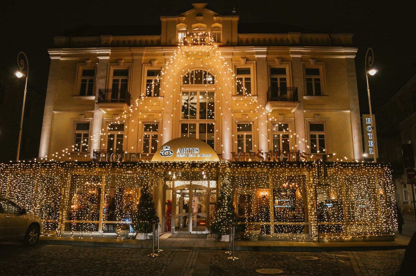 Building decorated with bright christmas lights at night